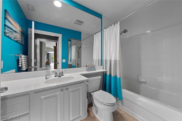 full bathroom featuring vanity, toilet, tile patterned flooring, and shower / bathtub combination with curtain