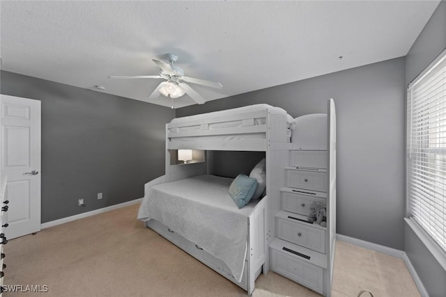 bedroom with ceiling fan and light colored carpet