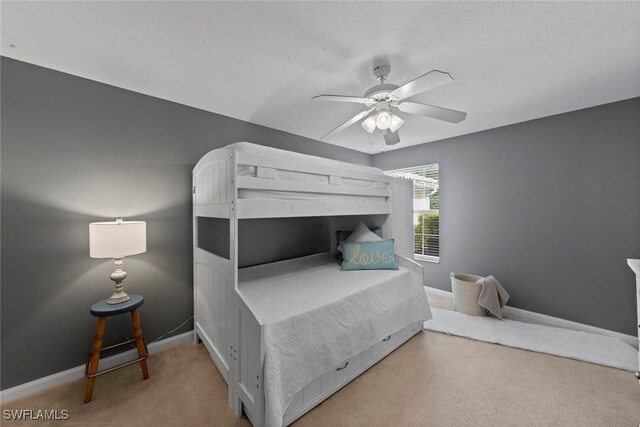 bedroom with ceiling fan and carpet flooring