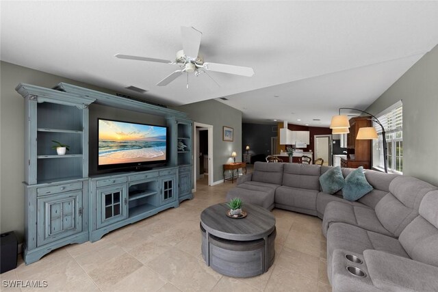 tiled living room featuring ceiling fan