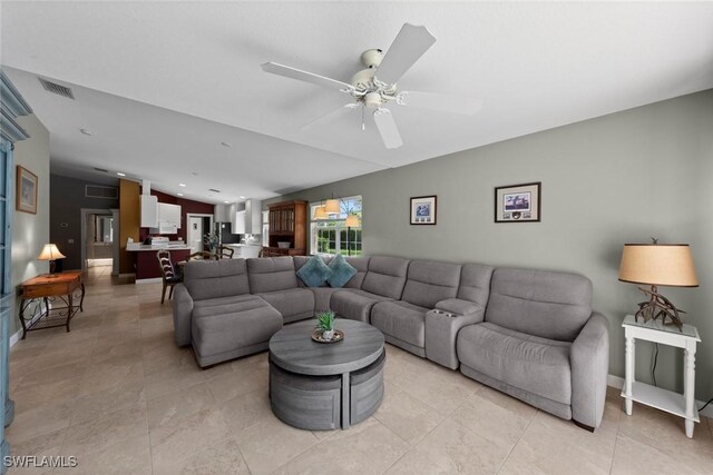 living room with ceiling fan and vaulted ceiling