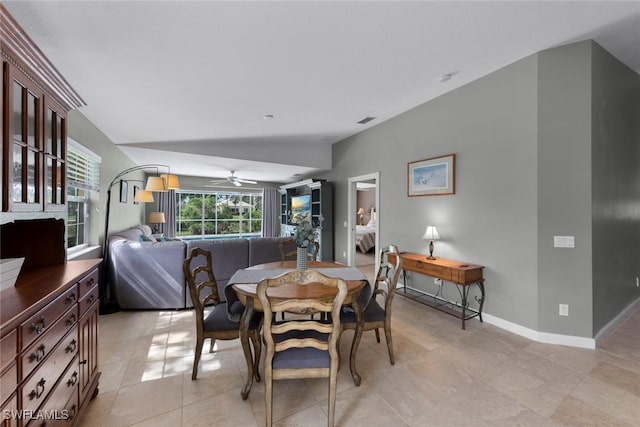 dining area featuring lofted ceiling and ceiling fan