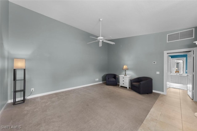 unfurnished room with ceiling fan, light carpet, and lofted ceiling