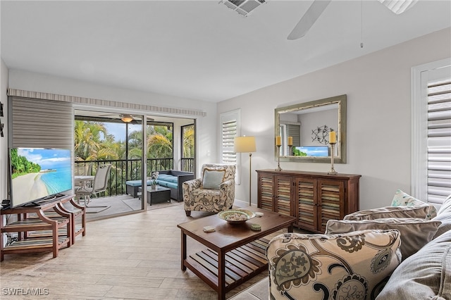 living room featuring light wood-type flooring and ceiling fan