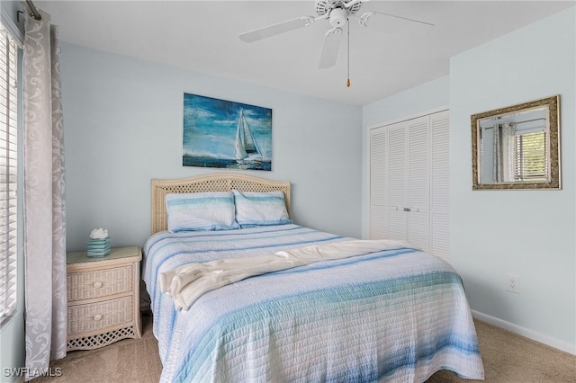 bedroom with a closet, ceiling fan, and carpet