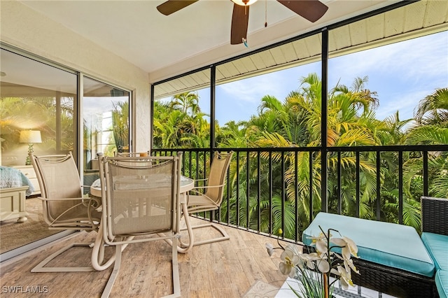 sunroom / solarium featuring ceiling fan