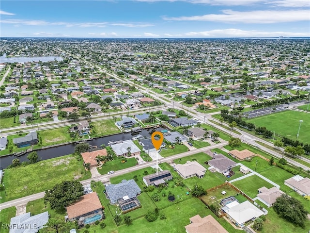 birds eye view of property with a residential view and a water view