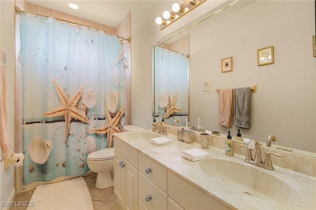 bathroom with toilet, double vanity, a sink, and tile patterned floors