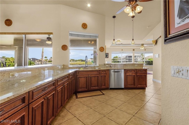 kitchen with hanging light fixtures, a ceiling fan, a sink, light stone countertops, and dishwasher