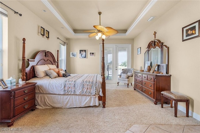 bedroom with light carpet, visible vents, a raised ceiling, ceiling fan, and access to exterior