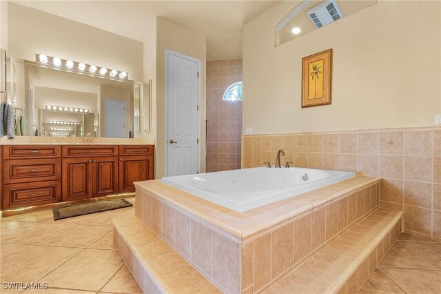 full bath featuring a garden tub, tile patterned flooring, visible vents, and vanity