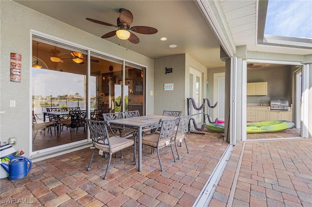 view of patio / terrace featuring ceiling fan, outdoor dining area, and area for grilling