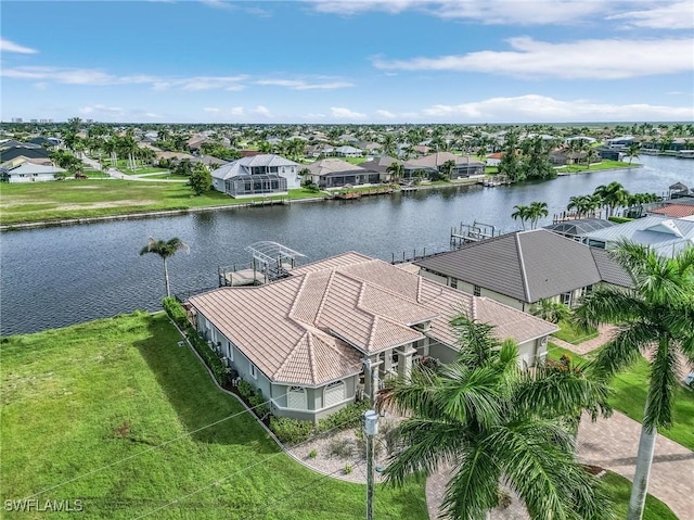 drone / aerial view featuring a water view and a residential view