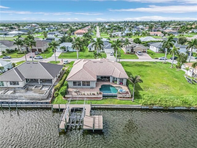 birds eye view of property with a water view and a residential view