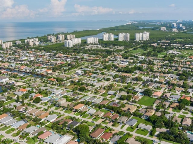 birds eye view of property with a water view and a city view