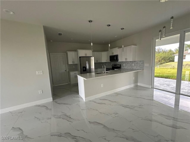 kitchen featuring white cabinetry, sink, backsplash, hanging light fixtures, and stainless steel fridge with ice dispenser