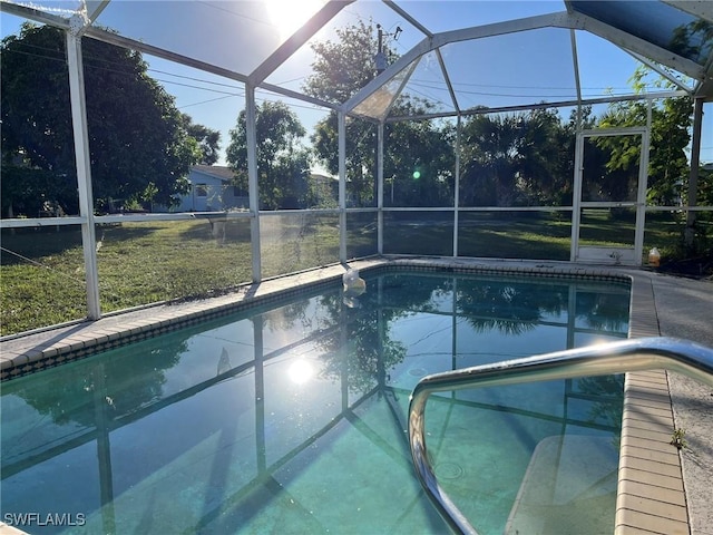 view of swimming pool featuring a lanai