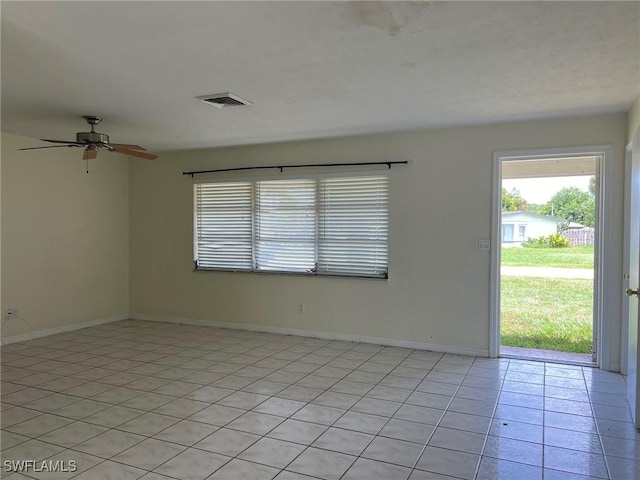 empty room featuring ceiling fan and light tile patterned floors