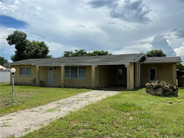 single story home with a front yard and a carport