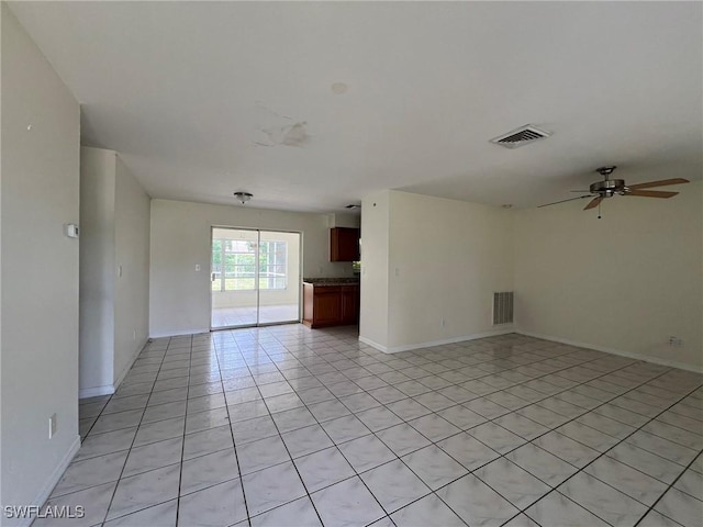 tiled empty room with ceiling fan