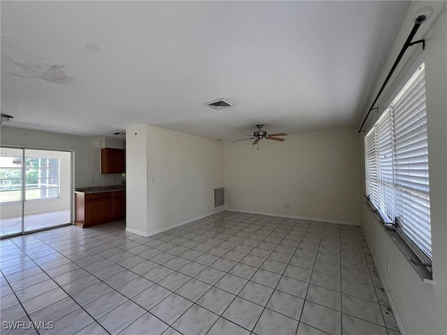 tiled empty room with ceiling fan