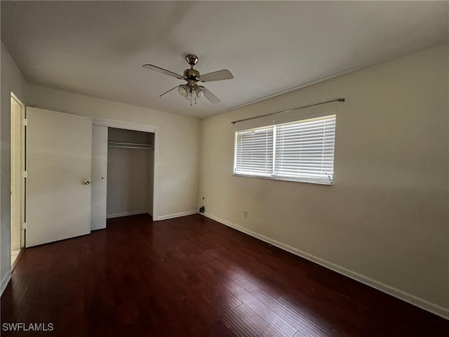 unfurnished bedroom featuring ceiling fan, dark hardwood / wood-style floors, and a closet