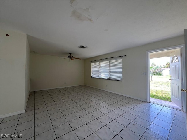 empty room with light tile patterned floors and ceiling fan