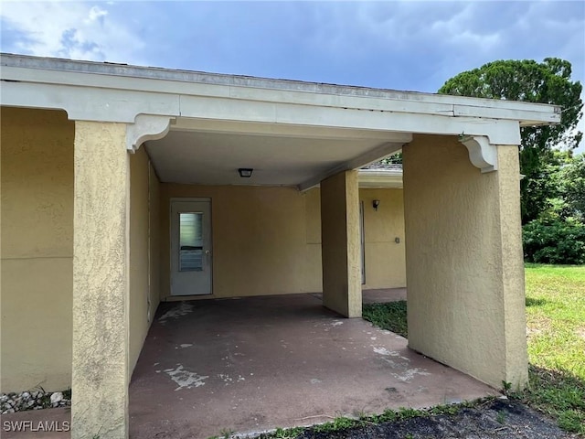 property entrance featuring a carport