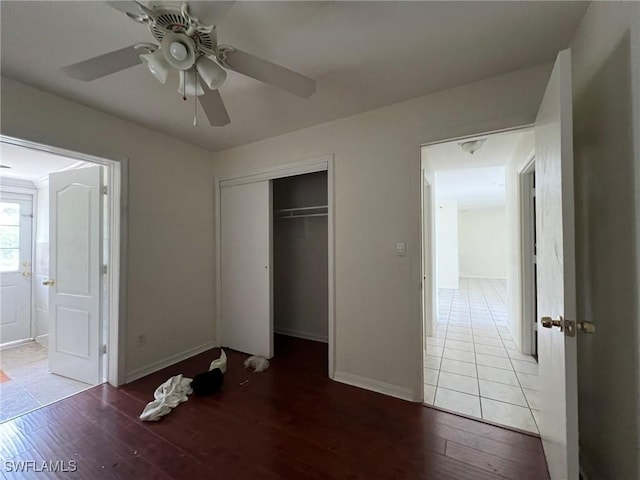 unfurnished bedroom featuring a closet, ceiling fan, and hardwood / wood-style floors