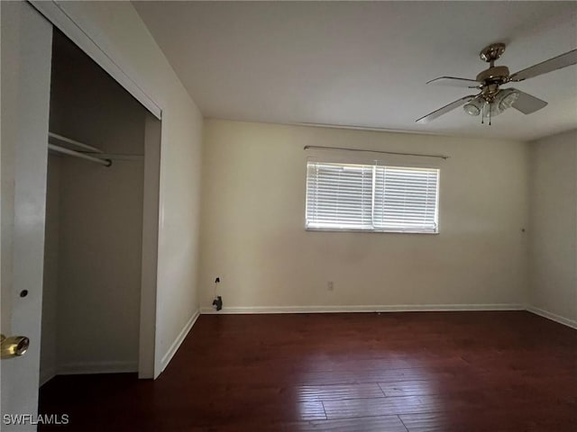 unfurnished bedroom featuring a closet, ceiling fan, and dark wood-type flooring