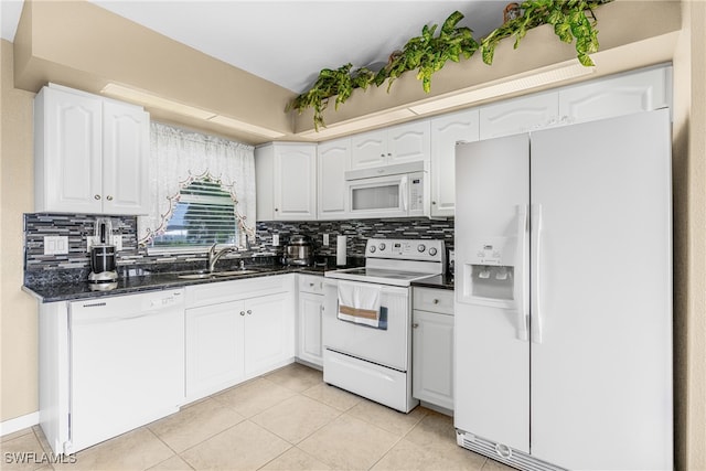 kitchen with white cabinets, light tile patterned floors, white appliances, sink, and decorative backsplash