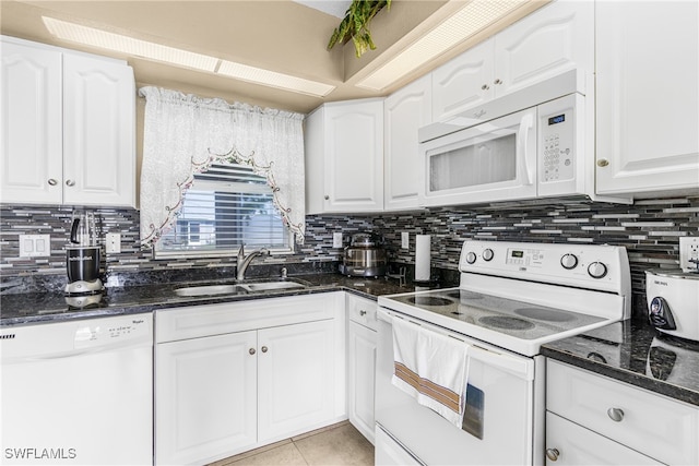 kitchen with sink, white appliances, white cabinets, and tasteful backsplash