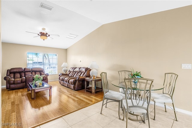 living room featuring lofted ceiling, ceiling fan, and light wood-type flooring