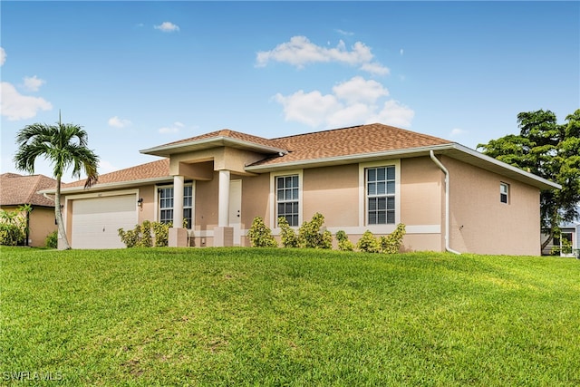 view of front of home with a garage and a front yard