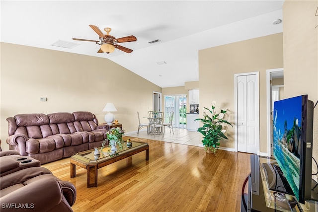 living room featuring light wood-type flooring, ceiling fan, and vaulted ceiling