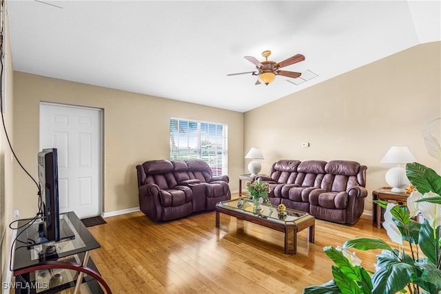 living room featuring lofted ceiling, ceiling fan, and light hardwood / wood-style flooring