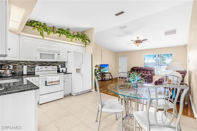 kitchen featuring white appliances, tasteful backsplash, light hardwood / wood-style floors, ceiling fan, and white cabinets