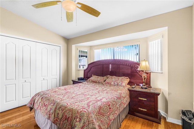 bedroom with a closet, ceiling fan, and light hardwood / wood-style flooring