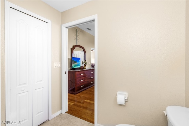 bathroom featuring toilet and hardwood / wood-style flooring