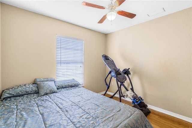 bedroom with ceiling fan and wood-type flooring