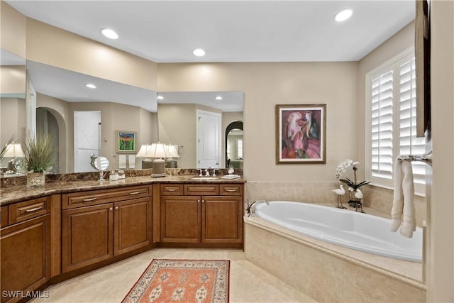 bathroom featuring recessed lighting, tile patterned flooring, vanity, and a bath