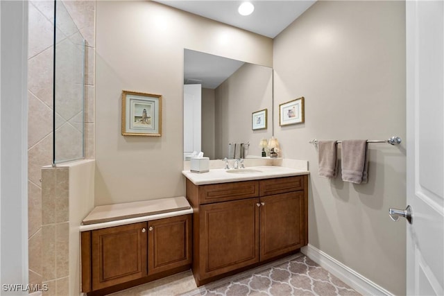 bathroom featuring baseboards and vanity