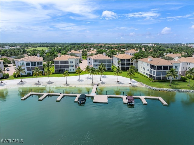 drone / aerial view featuring a residential view and a water view