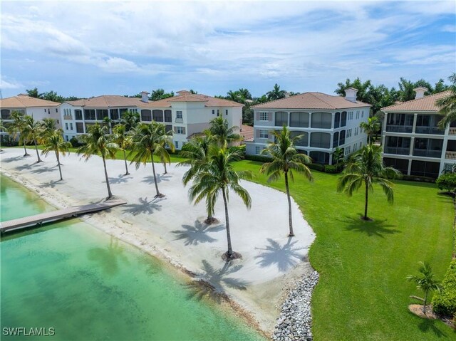 view of community with a water view, a residential view, and a lawn