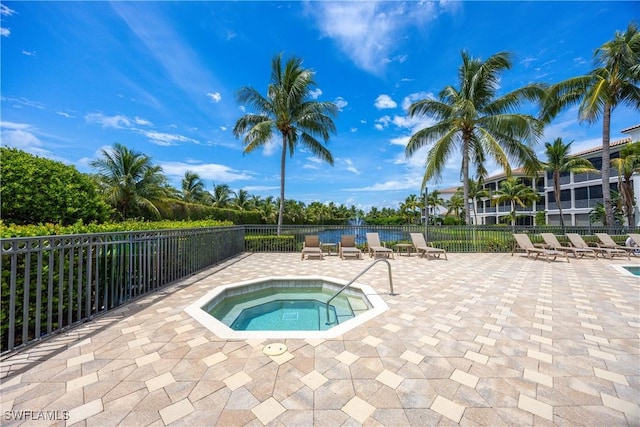 view of pool with a patio area and a hot tub