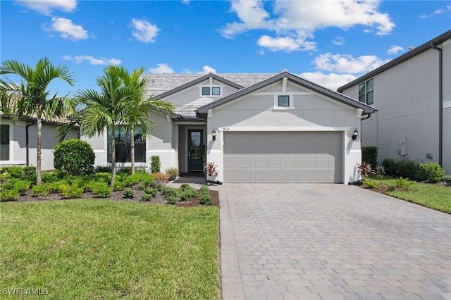 view of front of home featuring a front yard and a garage