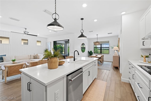 kitchen with dishwasher, white cabinetry, light hardwood / wood-style floors, and a kitchen island with sink