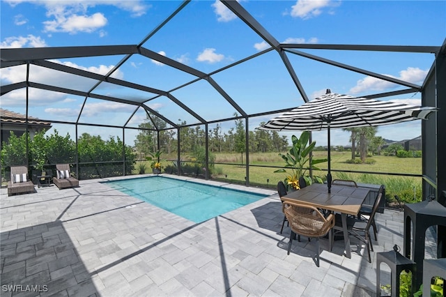 view of pool featuring a patio and glass enclosure