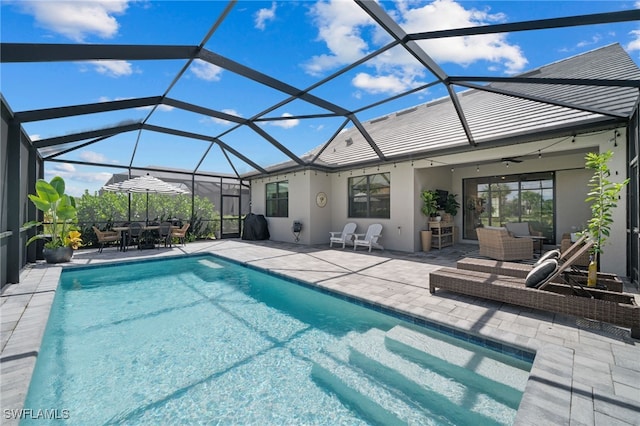 view of pool featuring glass enclosure and a patio area