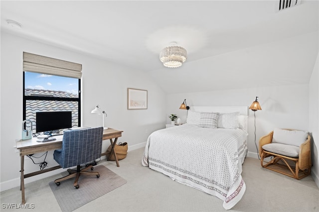 bedroom with carpet floors and vaulted ceiling